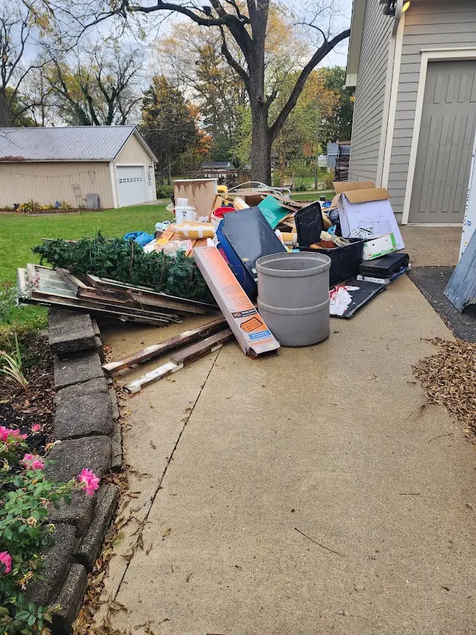 Dumpster being loaded with debris for Residential Dumpster Rental in De Witt